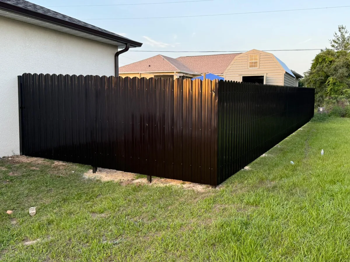 Black Dura Fence residential corner install with white home — Marion County FL