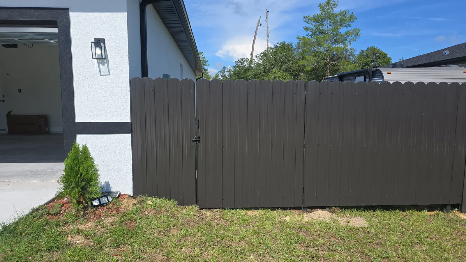 Bronze Dura Fence with gate next to garage — Marion County FL