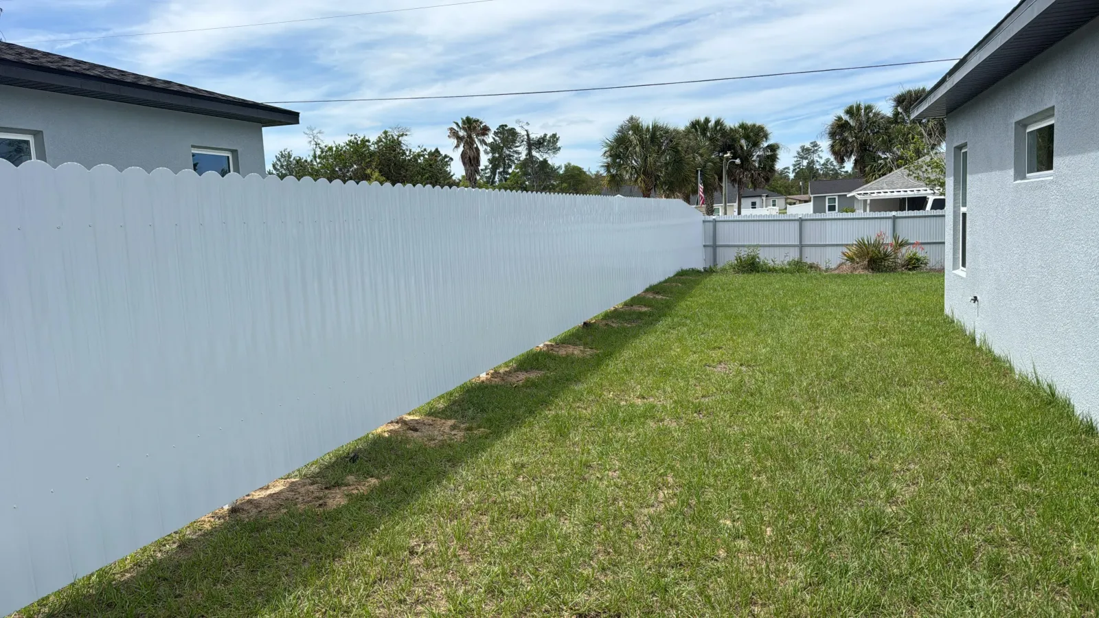 White Dura Fence next to driveway and garage — Ocala FL