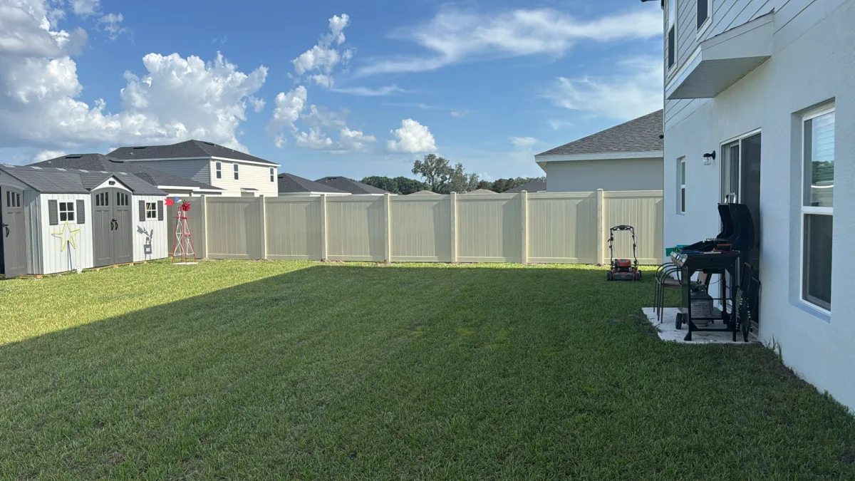 Tan cream vinyl privacy fence side yard between homes — Marion County FL