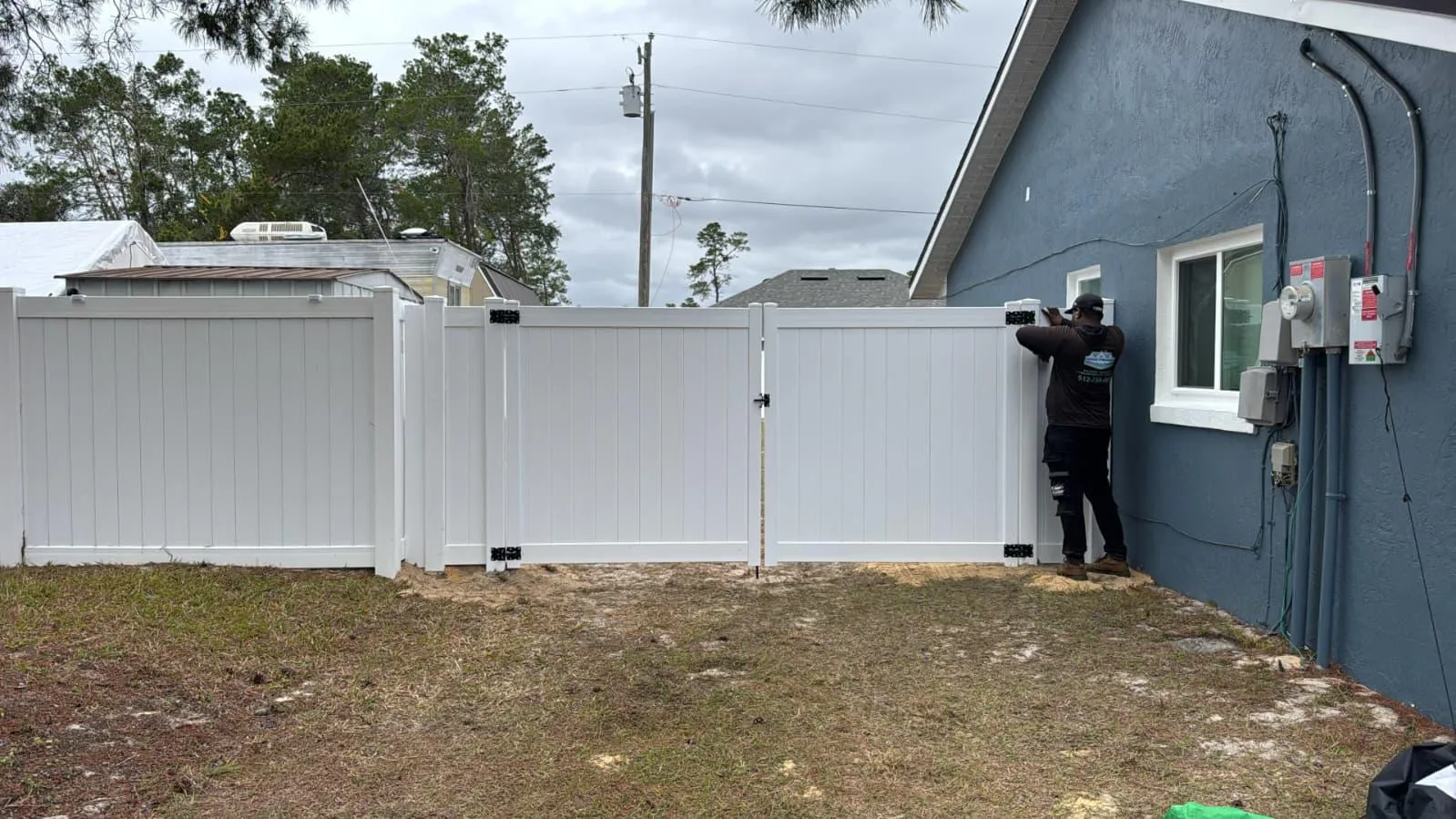 White vinyl privacy fence wrapping backyard — Marion County FL