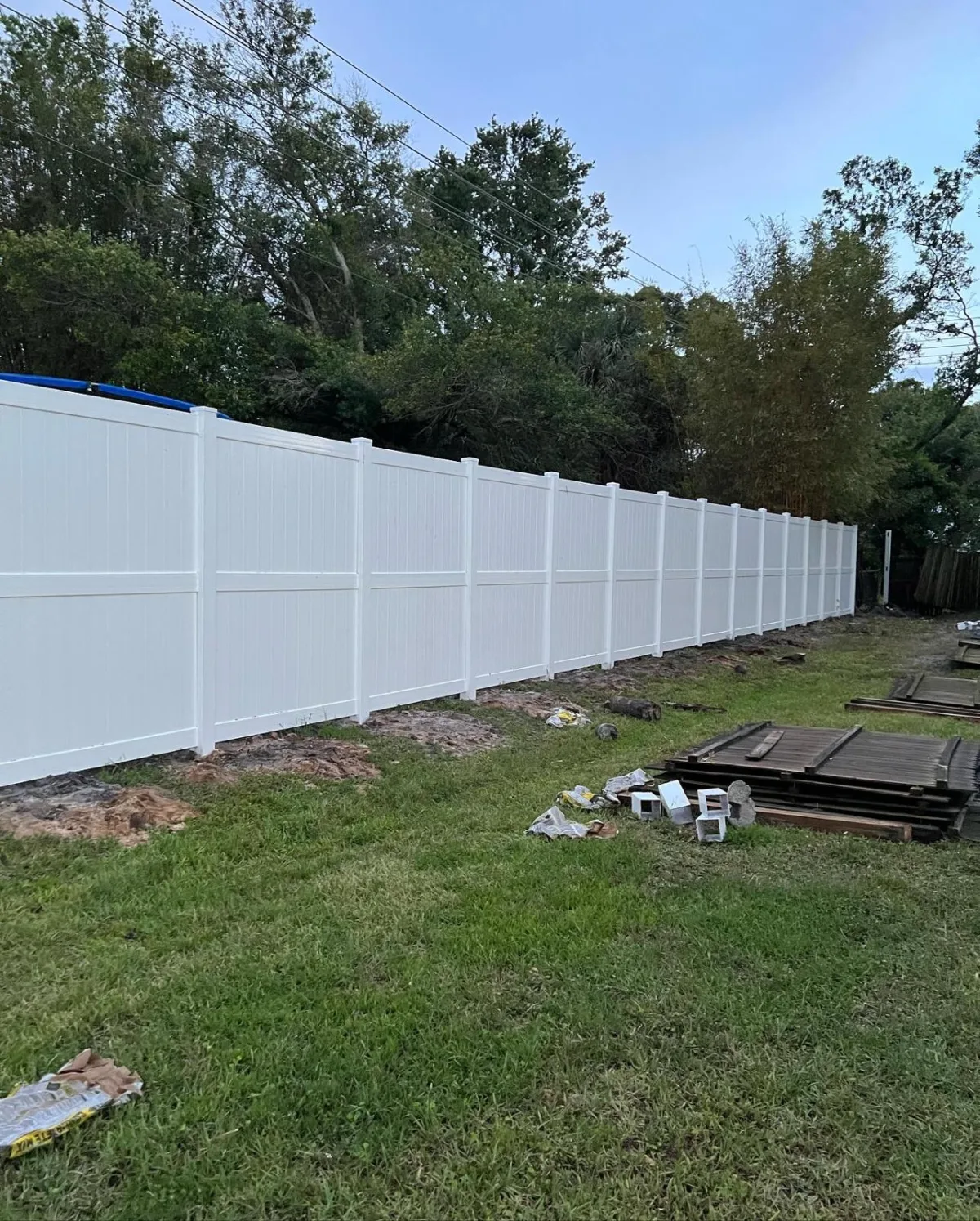 White vinyl privacy fence long run during install — Marion County FL