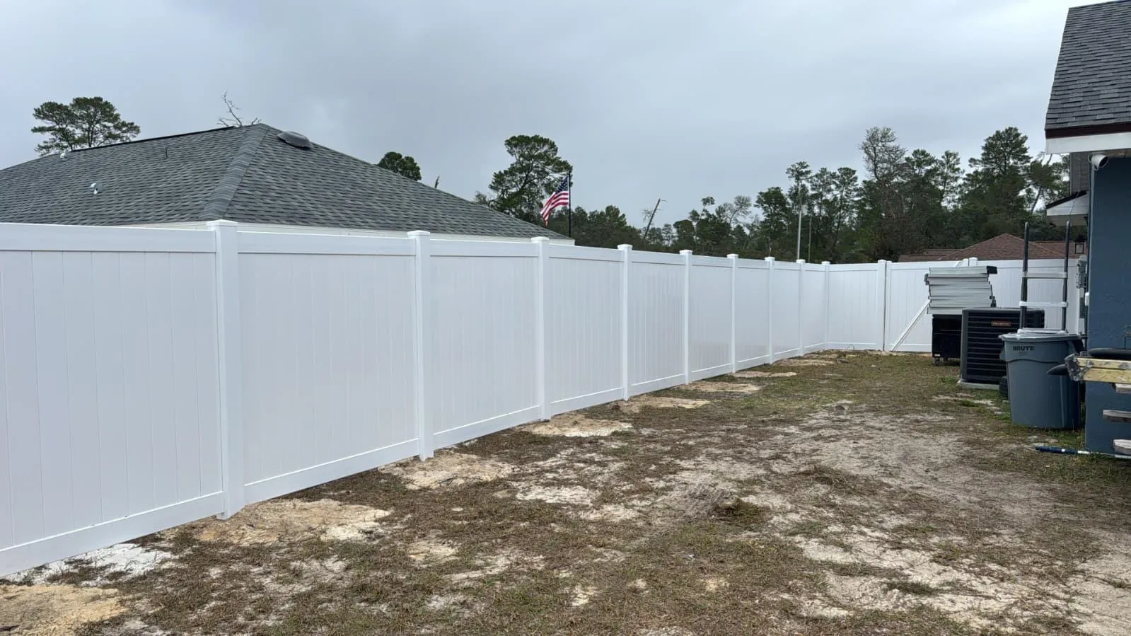 White vinyl privacy fence panels with double-swing gate — Ocala FL