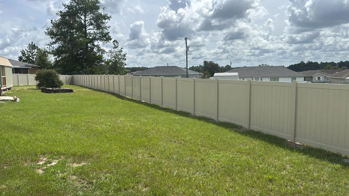 White vinyl privacy fence with driveway gate — Ocala FL